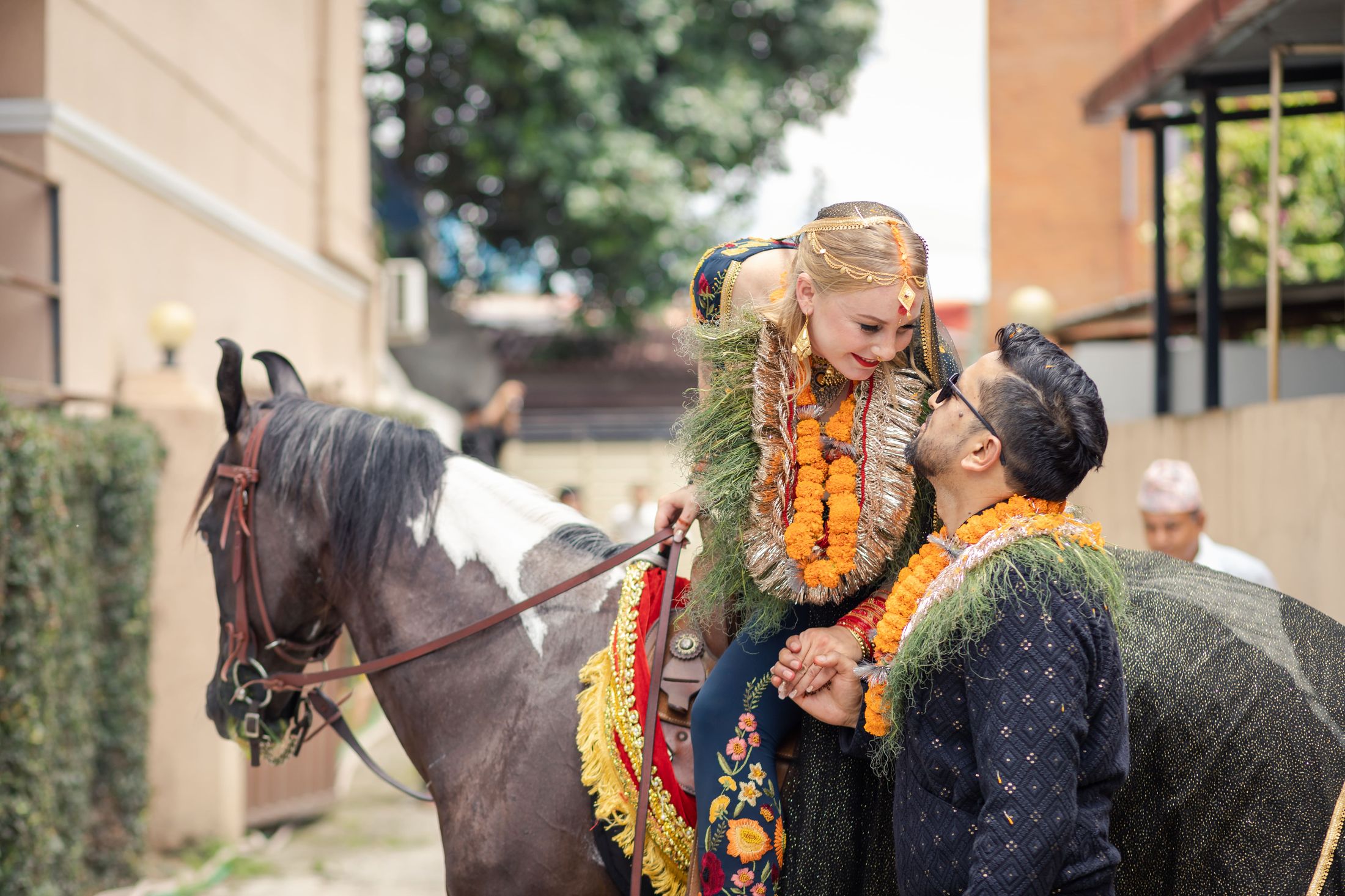 Jana leaning down from the horse to embrace Raymon as he guides it on foot